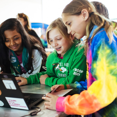 Girl Scout Juniors learning through a laptop.