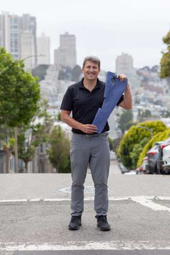 Man stands with CIONIC mobility pants on a hill in San Francisco