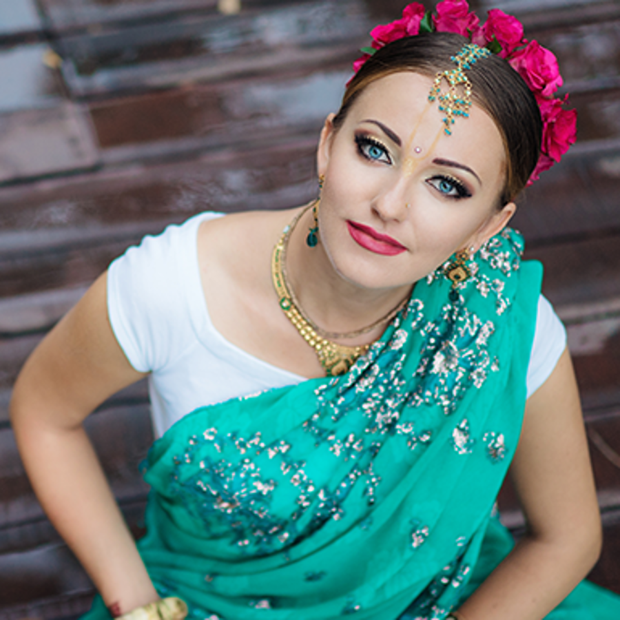 Indian woman with light blue eyes wearing traditional clothing.
