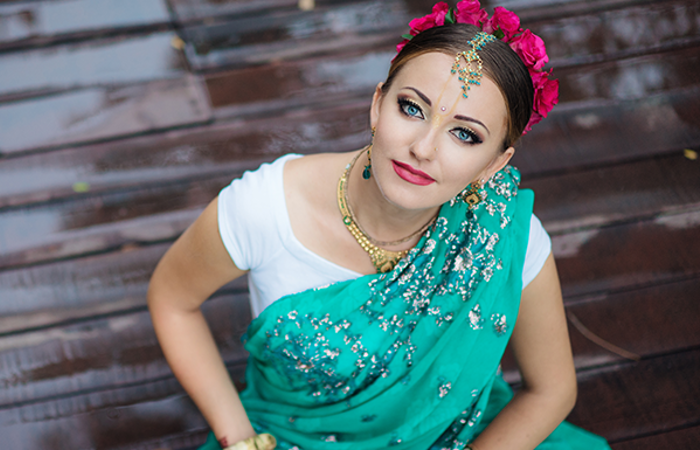 Indian woman with light blue eyes wearing traditional clothing.