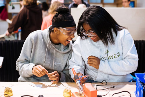 Two girls share excitement while doing a science project at The Tech Interactive.