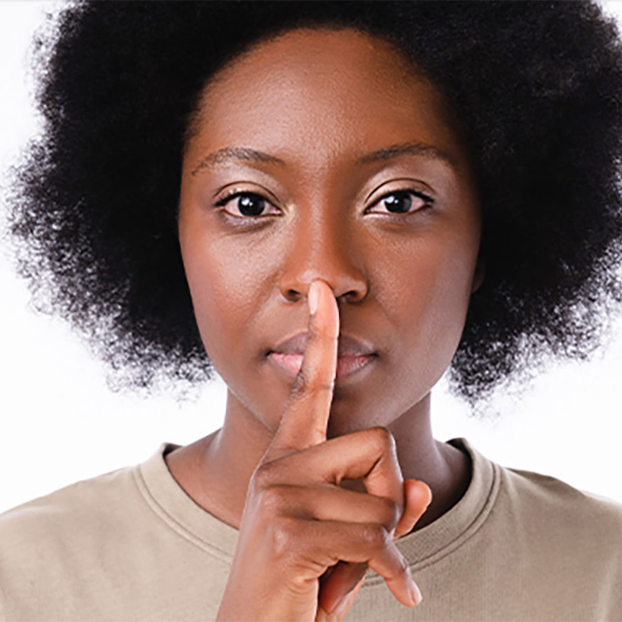 Woman using silence gesture.