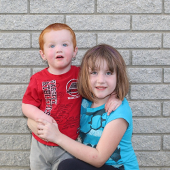 A boy with red hair and a girl with brown hair.