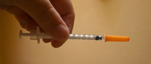 A syringe containing insulin.