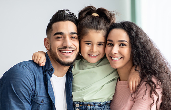 A happy child with their mother and father.