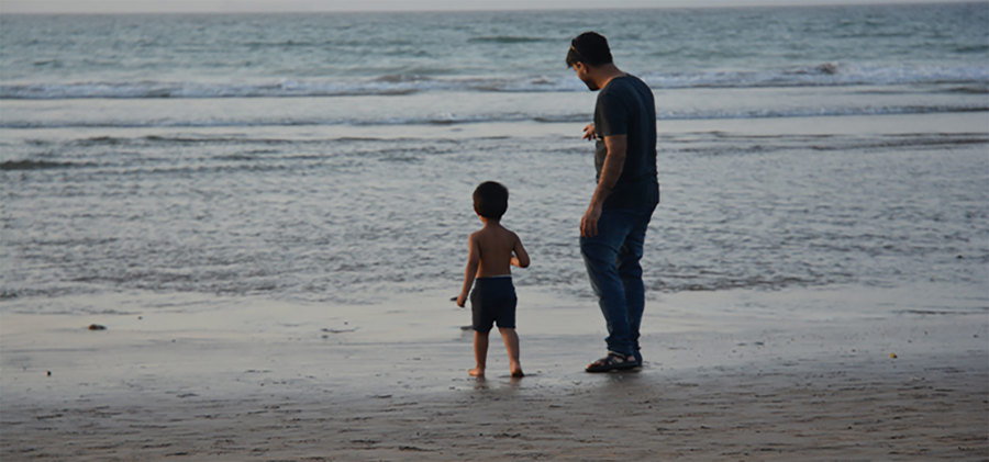 Man and child on a beach.