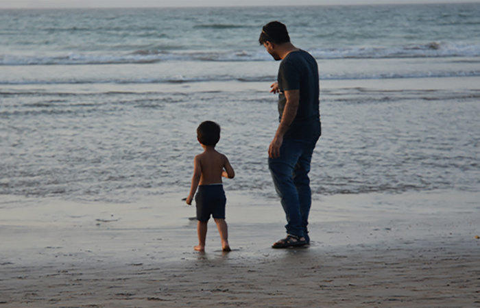 Man and child on a beach.