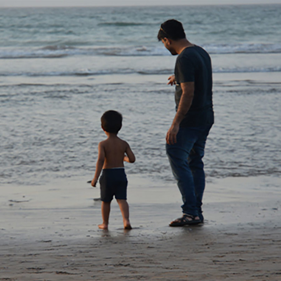 Man and child on a beach.