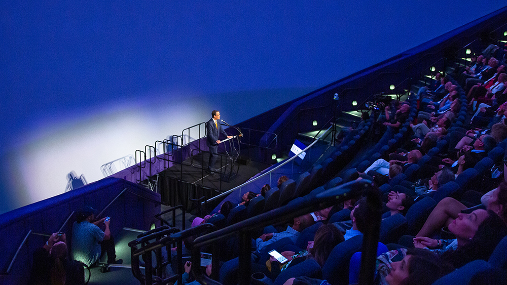 An announcement event taking place at the IMAX Dome Theater.