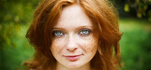 A red-haired girl with blues eyes and freckles.