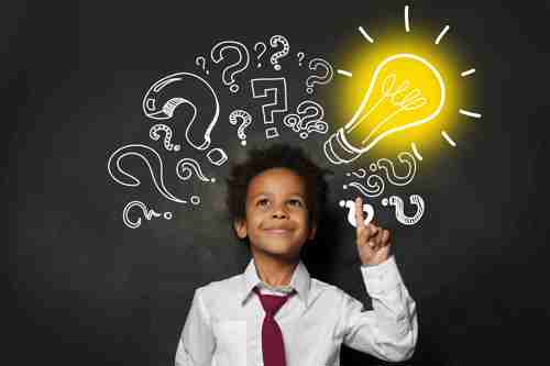 Child in front of chalkboard