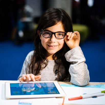 Happy girl engaging in a STEM activity.