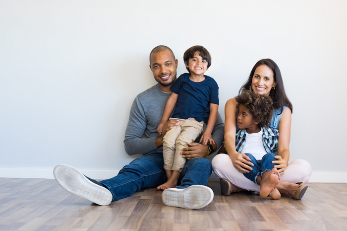 Family sitting on floor.