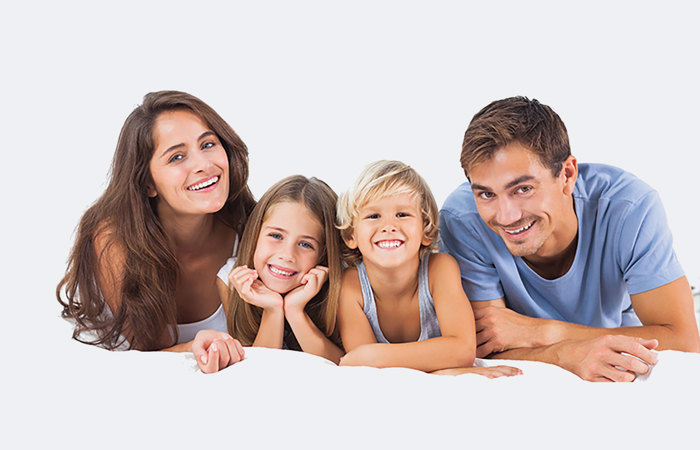 A happy family lying down together.