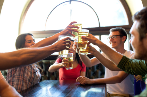 Image of people drinking beer together at a bar