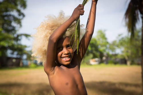 A child with blonde hair from the Solomon Islands.