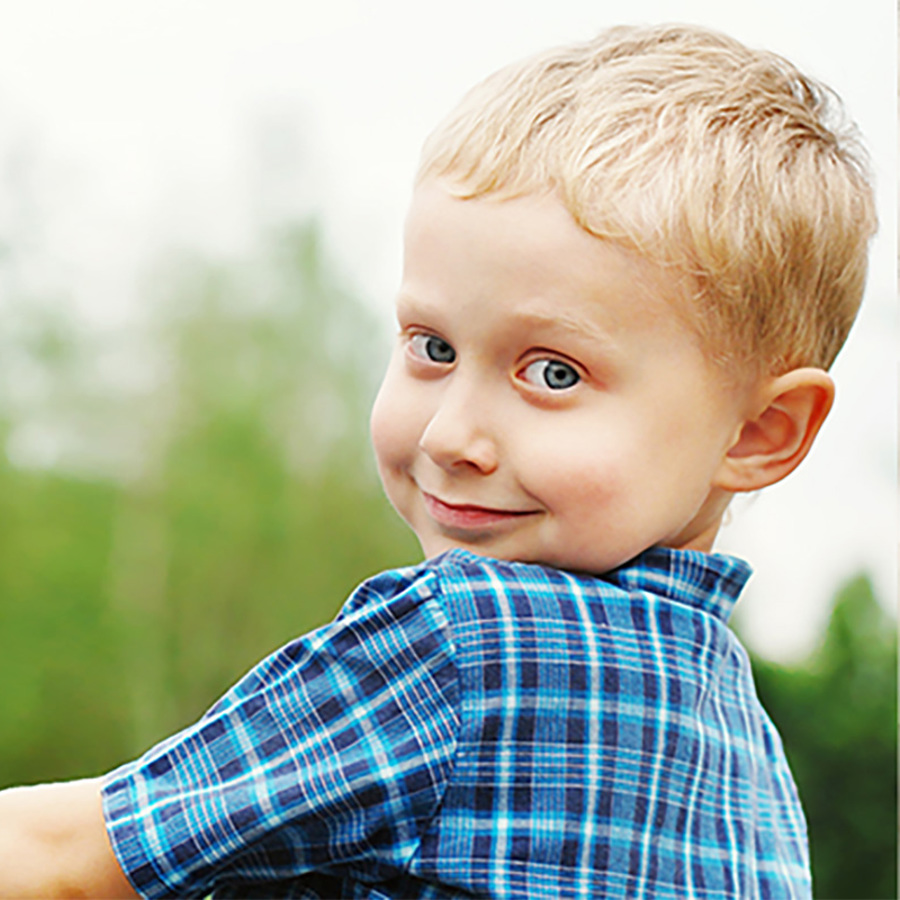 Little boy holding hand with father.