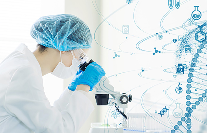 Scientist observing DNA through a microscope.