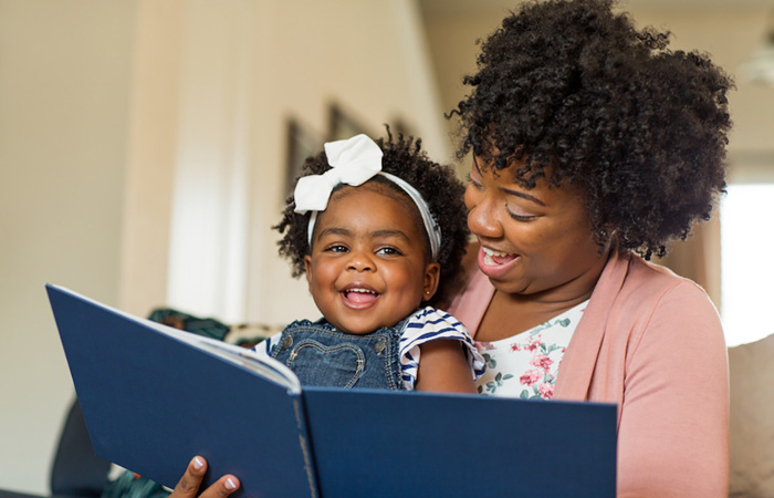 Mother and daughter reading a book together.