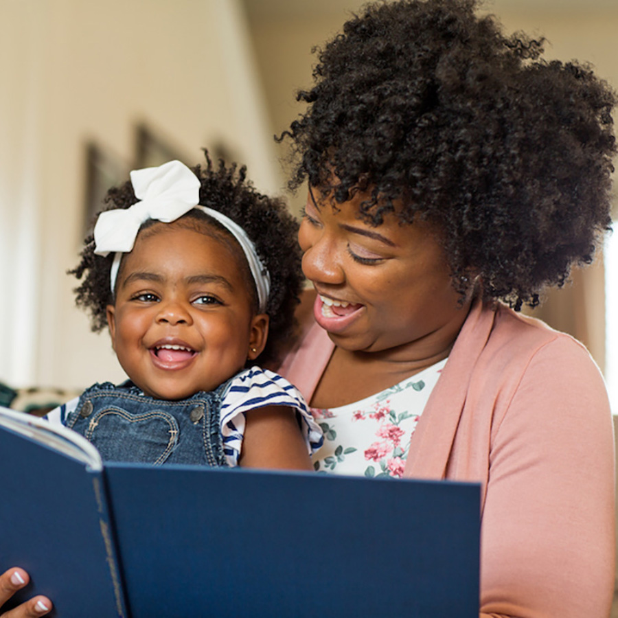 Mother and daughter reading a book together.
