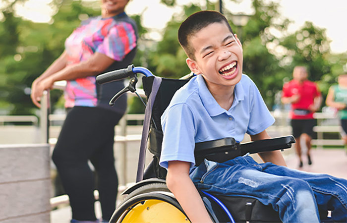 Child in wheelchair outdoors.