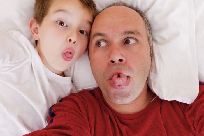 Tongue rolling father and child.