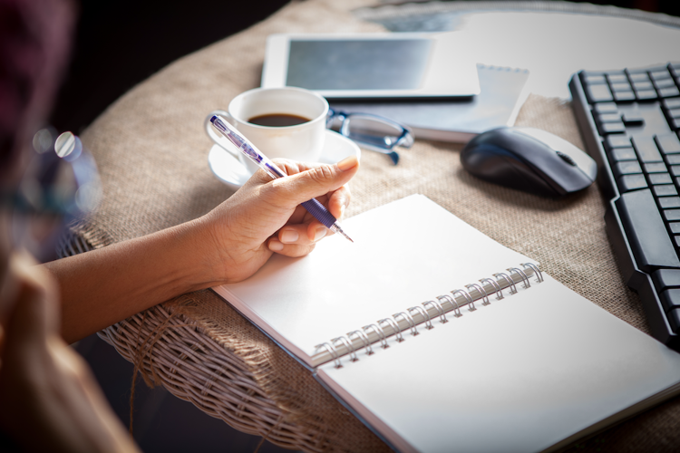 Woman writing with left hand.