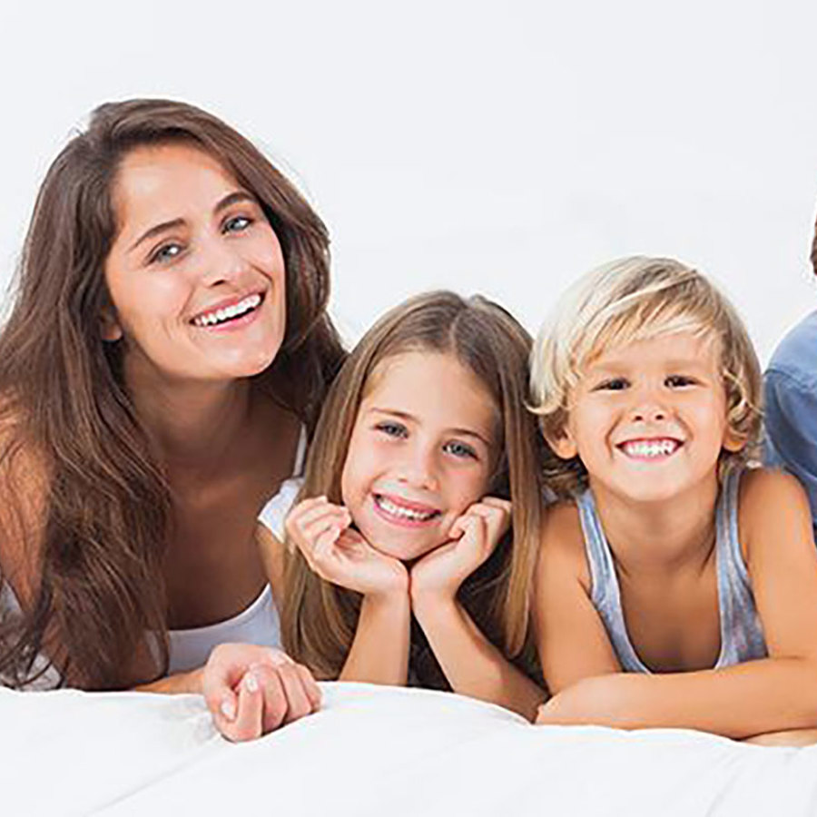 Family smiling while lying down.