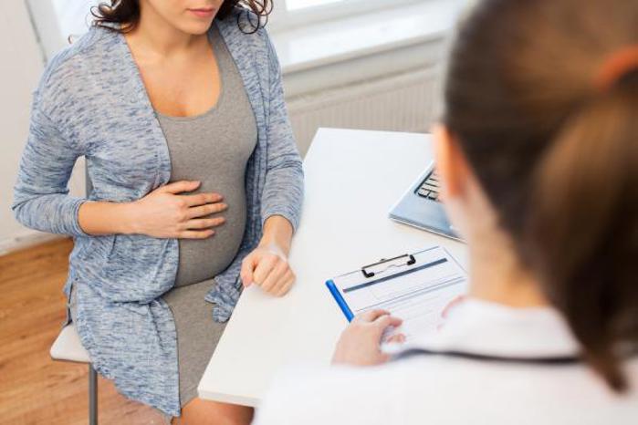 Genetic counseling with pregnant woman.