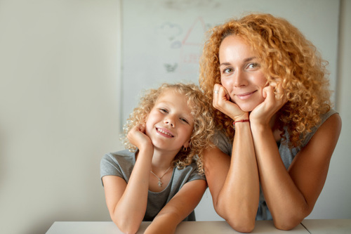 Mother and daughter with curly hair.