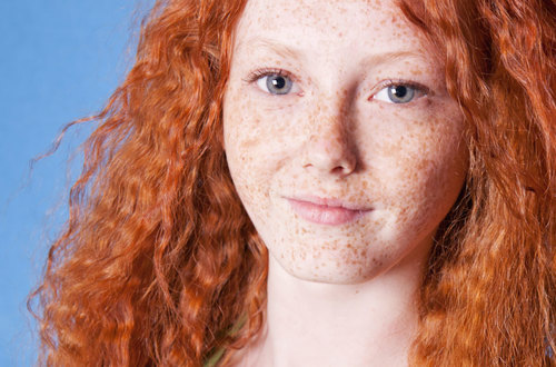 Woman with red hair and freckles.