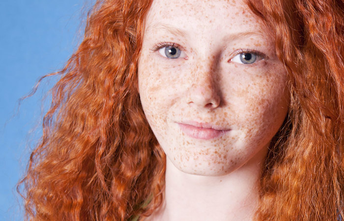 Woman with red hair and freckles.