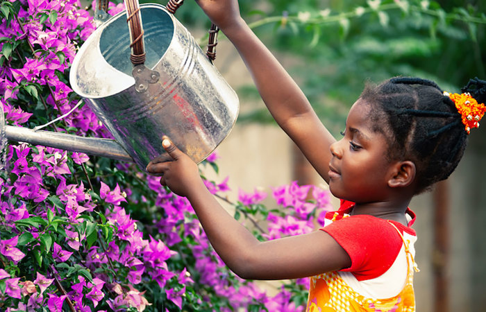 Girl watering flowers.