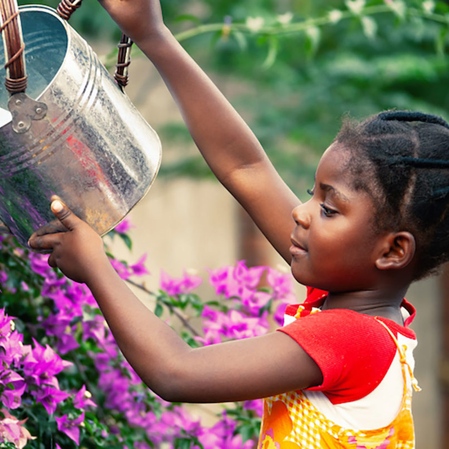 Girl watering flowers.