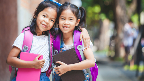 Twin girls with books