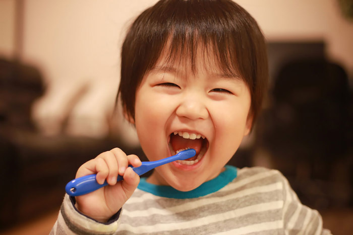 Child brushing their teeth.