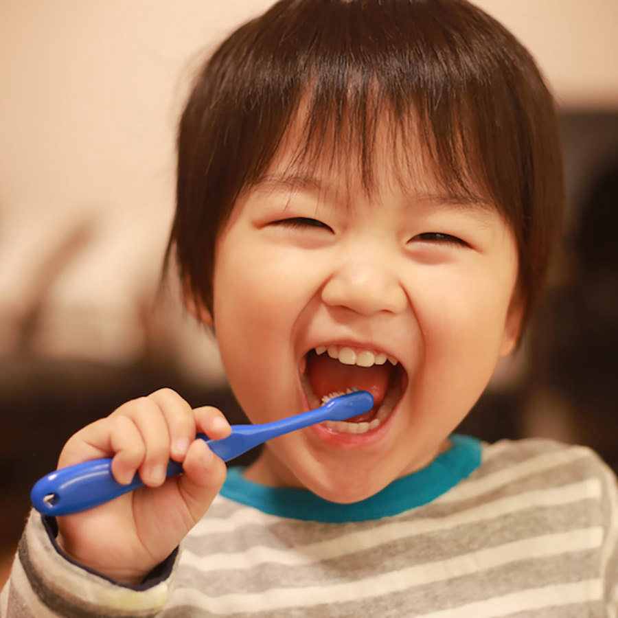 Child brushing their teeth.