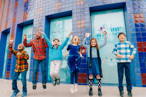 Six excited children outside of The Tech Interactive