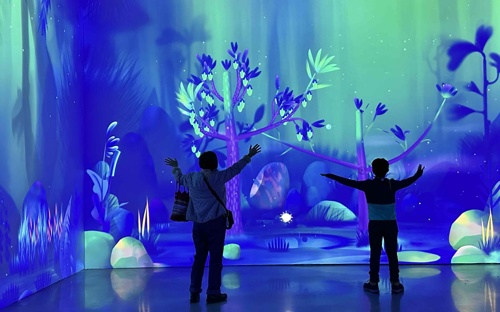 Mom and boy play with trees in Dream Garden