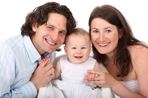 Smiling parents with a happy baby